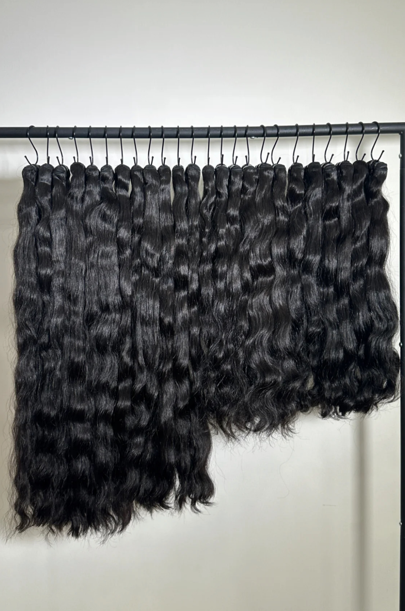 Black Woman wearing long raw human hair extensions premium unprocessed hair texture for SPadtress raw vs virgin hair comparison